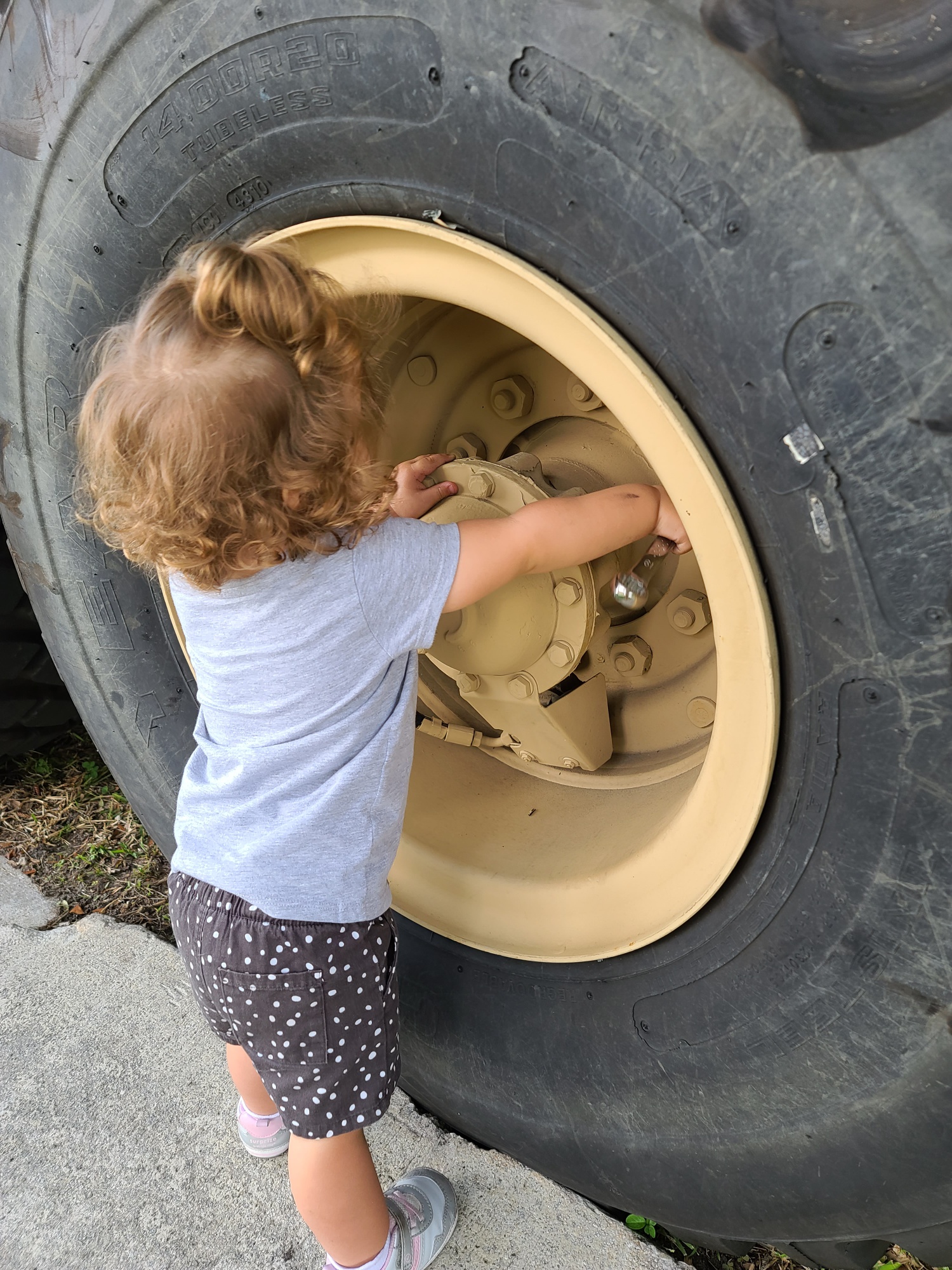 baby working on truck tire